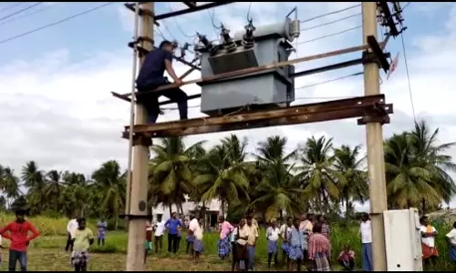 டிரான்ஸ்பார்மர், மின்கம்பத்தில் ஏறி அரசு ஊழியர் உள்பட 2 பேர் போராட்டம் டிரான்ஸ்பார்மர், மின்கம்பத்தில் ஏறி அரசு ஊழியர் உள்பட 2 பேர் போராட்டம்