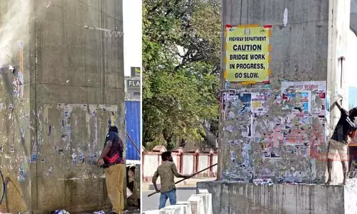 மேம்பால தூண்களில் சுவரொட்டிகளை அகற்றும் பணி