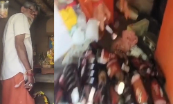 சாமி படங்களுக்கு இடையே மதுபான பாட்டில்கள் மறைத்து வைத்து விற்பனை