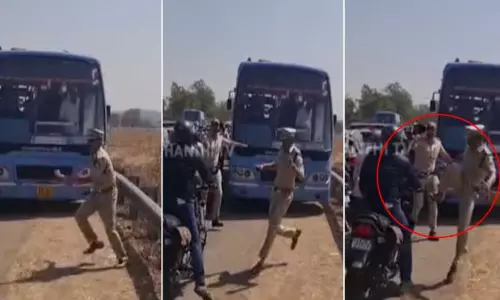 கர்நாடக முதல்-மந்திரி வருகை; போக்குவரத்தை சரிசெய்ய பைக் ஓட்டுநரை எட்டி உதைத்த போலீஸ் அதிகாரி